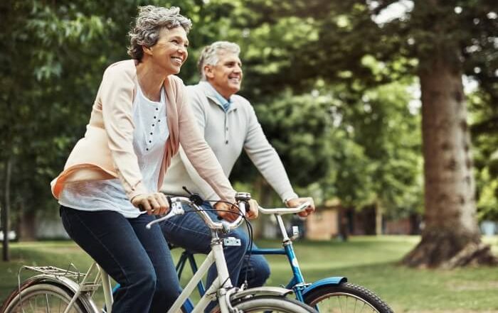 Active Senior Couple Riding a Bike - Cambridge Village
