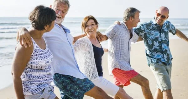 Group of people dancing on a beach